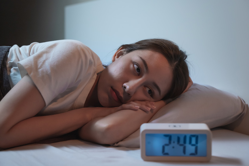 girl laying in bed at 2:49 am having trouble sleeping