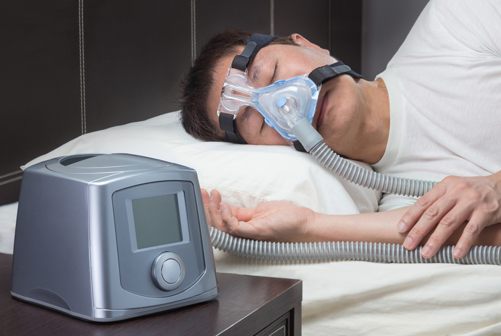 man, sleeping on his side with cpap machine