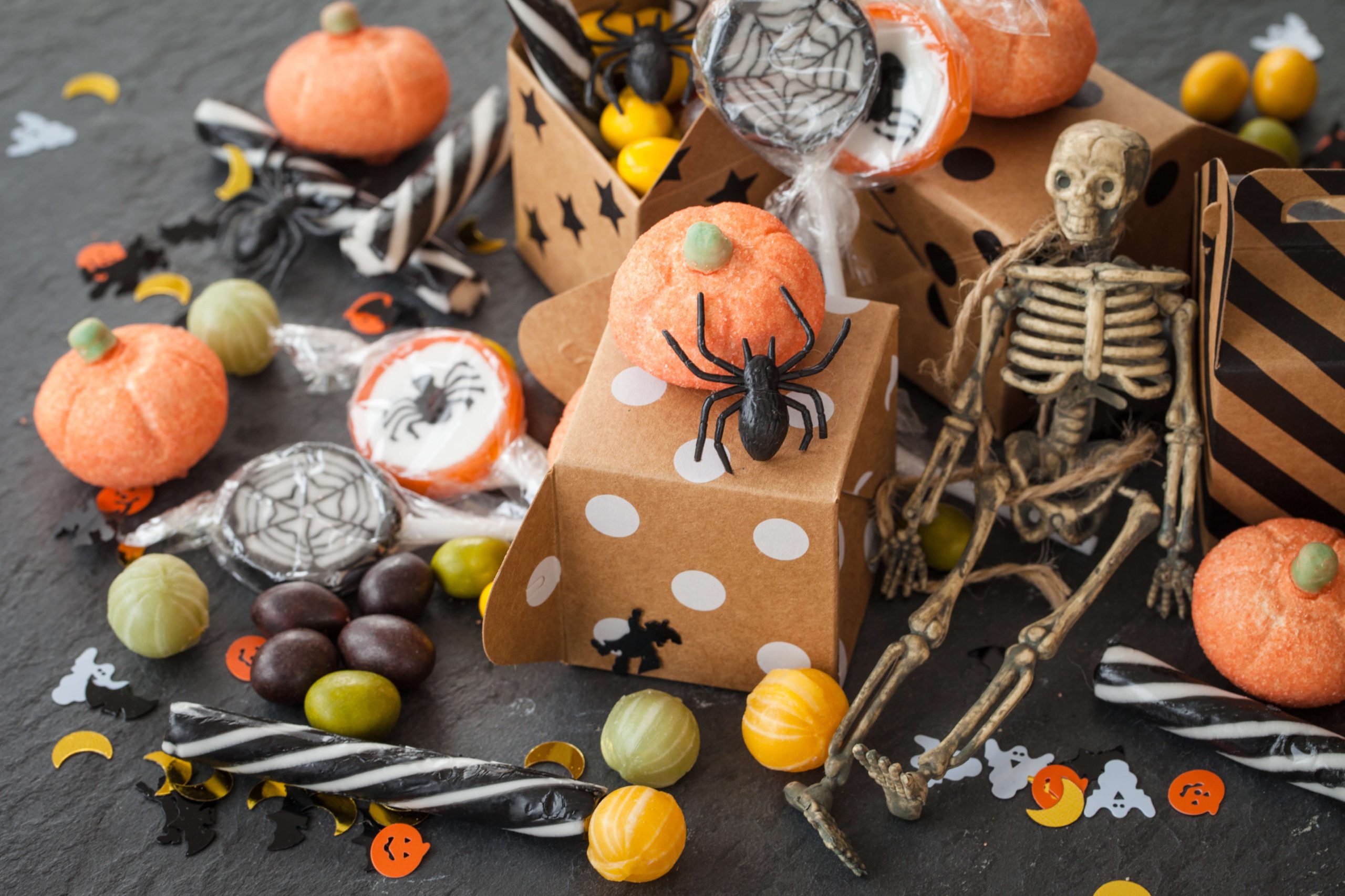 staged halloween candy with fake insects and skeleton