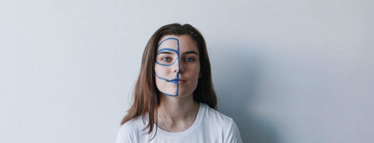 woman with blue lines on half of her face
