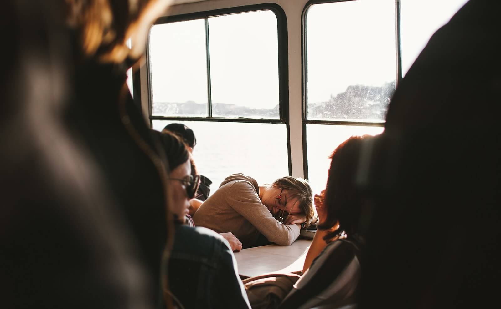 woman sleeping on crowded boat