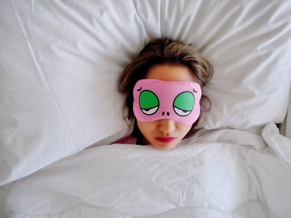 woman sleeping with comical sleep mask on
